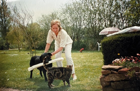 Mum with Joe the black lab (Simon's dog) and Ben the cat all in the garden at Heath-Beam Cottage