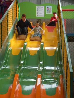 Grant taking nervous Harry down a slide