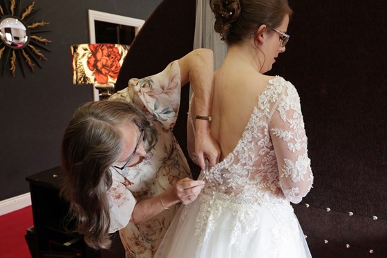 Helping to do buttons on Laura’s wedding dress