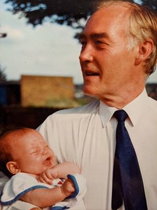 Mike with his first granddaughter at her christening 