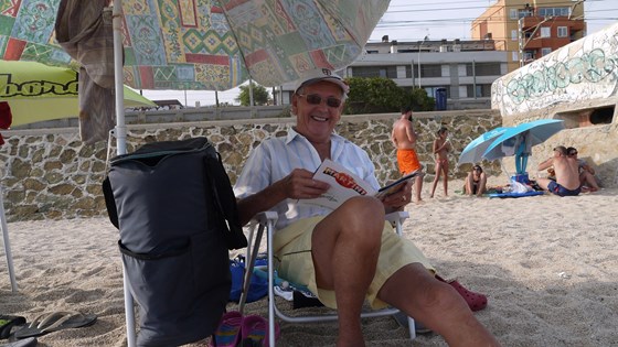 Familiar smile on the beach...always in the shade, but always tanned!