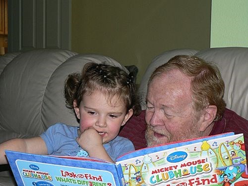 Grandad reading Joslyn a story