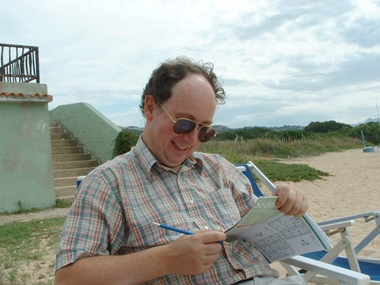 Justin doing a su-doko puzzle in Sardinia.