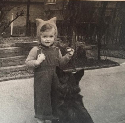 Julie showing an early love of dogs aged 2