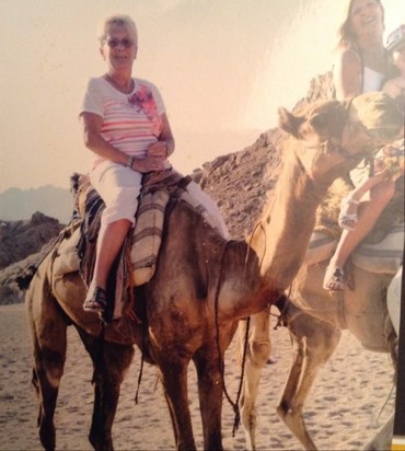 riding a camel in the Egyptian desert