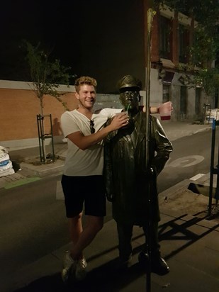 Offering a drink to a statue in Spain - Alex and Tiago nearby