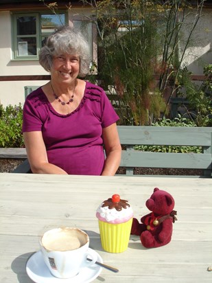Bridget with Michael the bear trying to eat a china cup cake