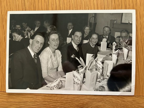 Mum and Dad at a Christmas Dinner, with his brother Harry and sister-in-law Kath, and Grandad in the background keen to finish his soup :)