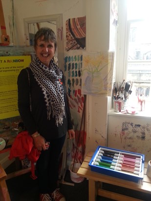 Charlie looking pleased with her floral drawing done at an art gallery .