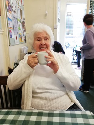 Betty drinking tea in Sid's cafe Holmfirth
