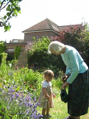 Peggy watering the garden with Mia, her great grand-daughter