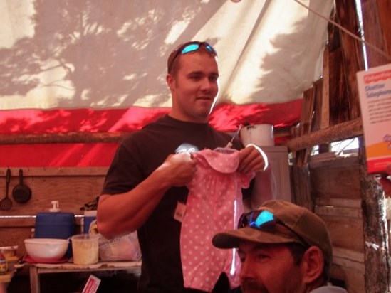 Trevor showing off his baby girl's pink outfit