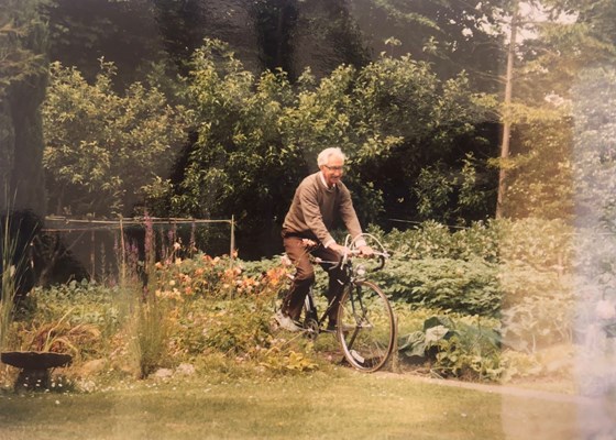 Cycling through his vegetable garden