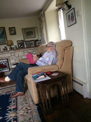 Colin with his grand daughters' pictures above him, in Valerie's and his beautiful home. 