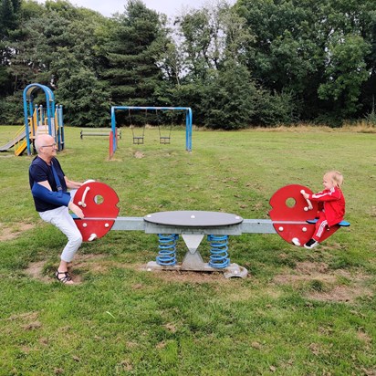 Nana and Yasha see-sawing and singing.