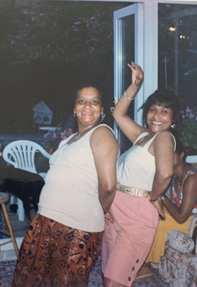 Suzy and Suzy cousins dancing at family BBQ