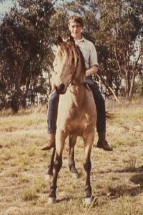 Kevin on brown horse in Australia