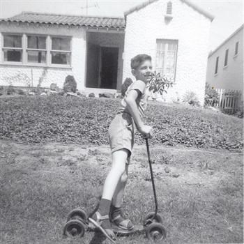 Age 7 - on his Scooter in Front of the House 