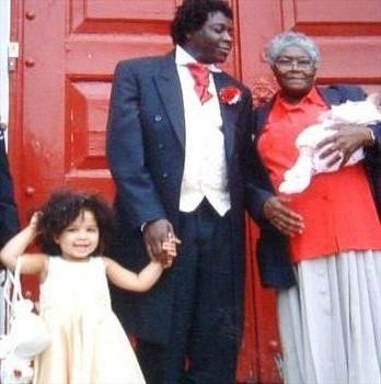 louise [as bridesmaid], Alvin and his mum, on Alvin's daughter, Carla's wedding day, London. 