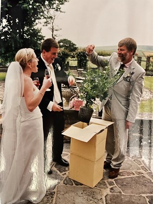 Uncle Robin presenting us with a gooseberry bush!! 3 children later does anyone want the kids!!