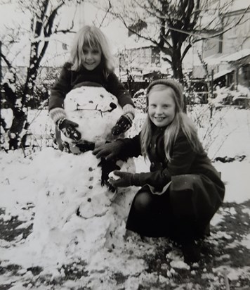 Mum with Laura, playing in the snow.