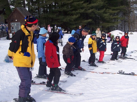 Shuang with kids in skiing