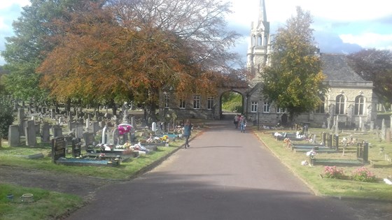 Binas grave under the autumnal tree near the chapel