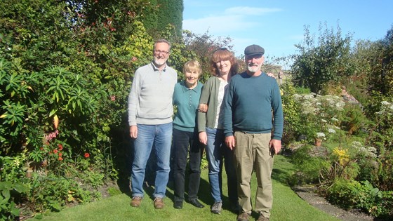 Mary in her garden with her grown up seedlings: John, Liz, Rob 2017