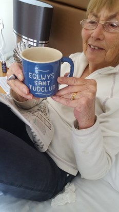 Mary enjoying a cuppa whilst doing the puzzles in the paper 2014