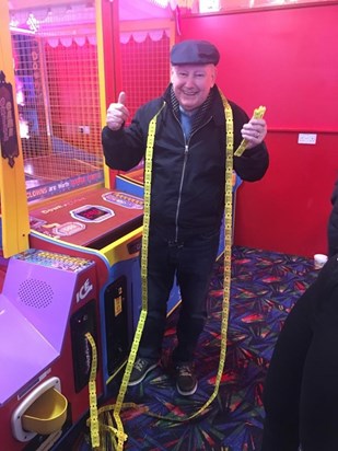 GRANDAD ENJOYING THE ARCADES AT THE SEASIDE