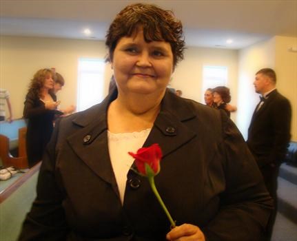 Mom at Allen's wedding with her favorite flower - a red rose