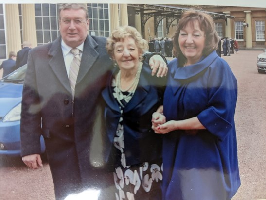 May with Tina and Del outside Buckingham Palace after receiving her MBE