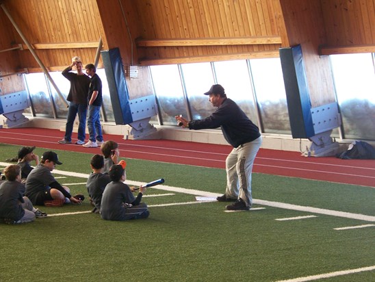 Stas showing kids how to bunt at one of his favorite events, the Lake Forest Police Baseball Clinic