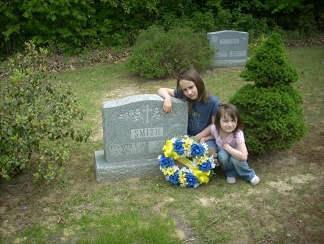 Kylie and MaKenna putting the flowers on yours and Grace's grave