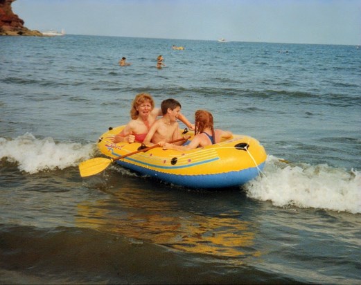 Lynne with children on holiday in a dinghy