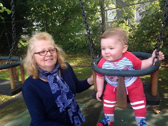 Lynne with Alex on a swing