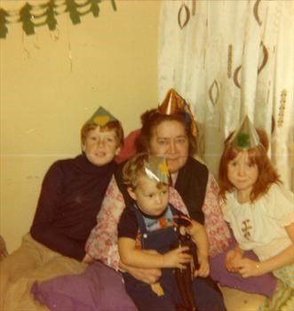 Mum with three of her Grandchildren at Christmas in 1977 - David, Emily & "Wee Trevor"