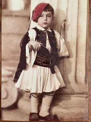 Young Menos in traditional Greek dress