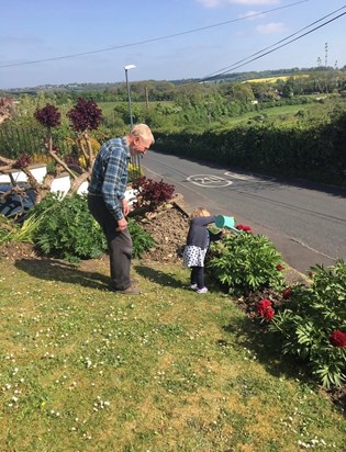 Ruby helping great grandad water the garden 