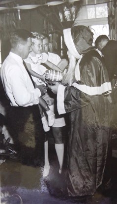 Dad with Deb meeting Father Christmas at the Naval party, Balmoral 1959