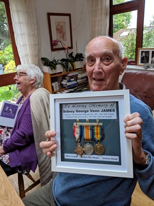 Proudly holding his dad's war medals