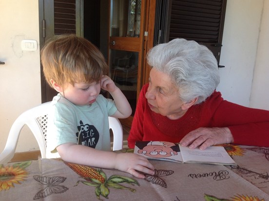 Reading to Samuel in Terracina to celebrate Liliana's 90th birthday. 