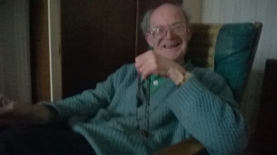 John in his flat, March 2014, holding his rosary