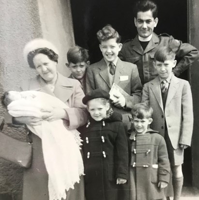 Ian‘s christening In Germany, Ray looking over our mums shoulder