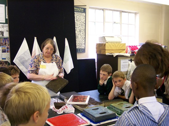 Demonstrating block printing at the Museum to a class from a local school