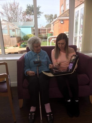 Mum and Claire looking at the book she loved so much with pictures and messages from all her family.