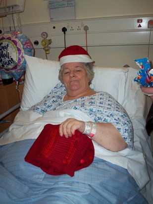 Mum unwrapping presents on Christmas Day 2010 in Hospital