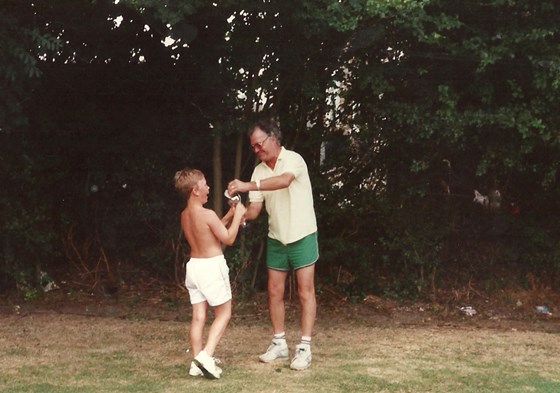 Bamps giving the annual tennis tournament trophy to Joe