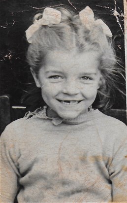 Mum as a young child with a smile