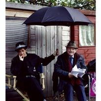 Lucy and David Jason on the Frost set, taking a break because of the rain. The picture appeared as a full page spread in the Radio Times